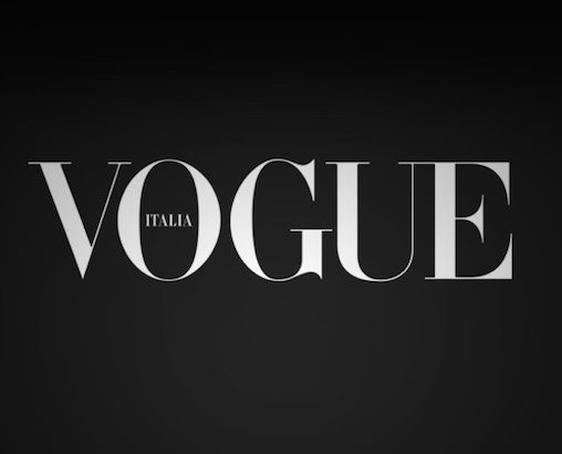 Black and white Vogue Italia magazine logo on dark background.