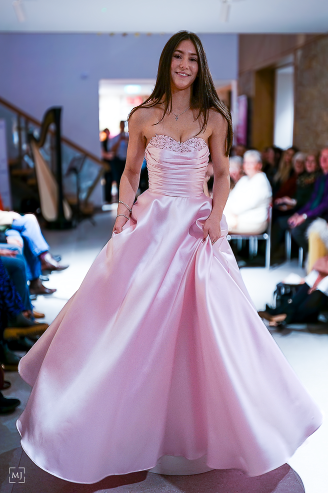 A pink satin ballgown dress is showcased in multiple angles, featuring a full skirt and strapless design.
