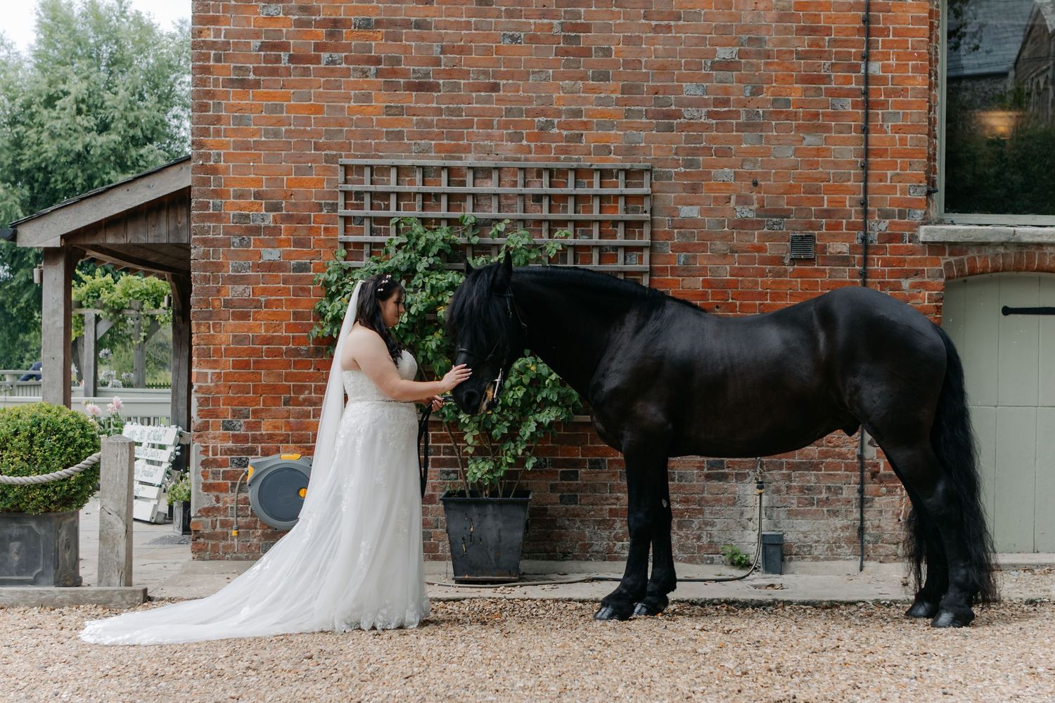 Outdoor view of a brick building with white wedding dress visible.