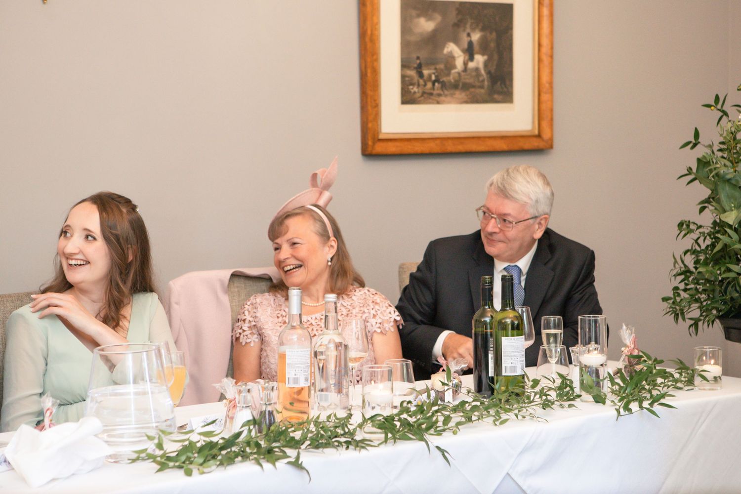 Long wedding reception table with guests enjoying celebration.