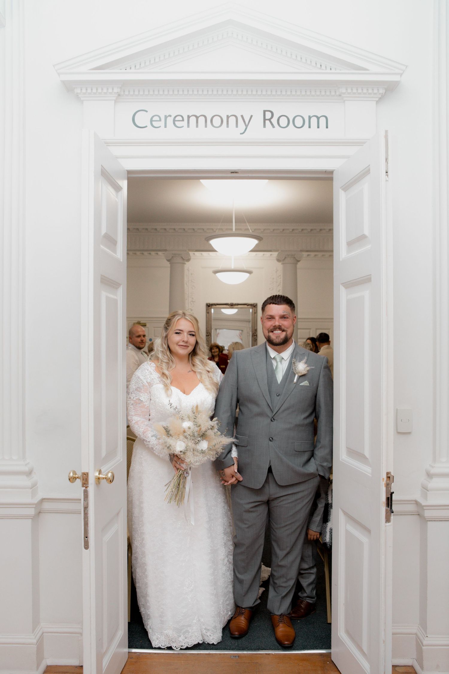 Wedding ceremony room entrance with white columns and elegant lighting.