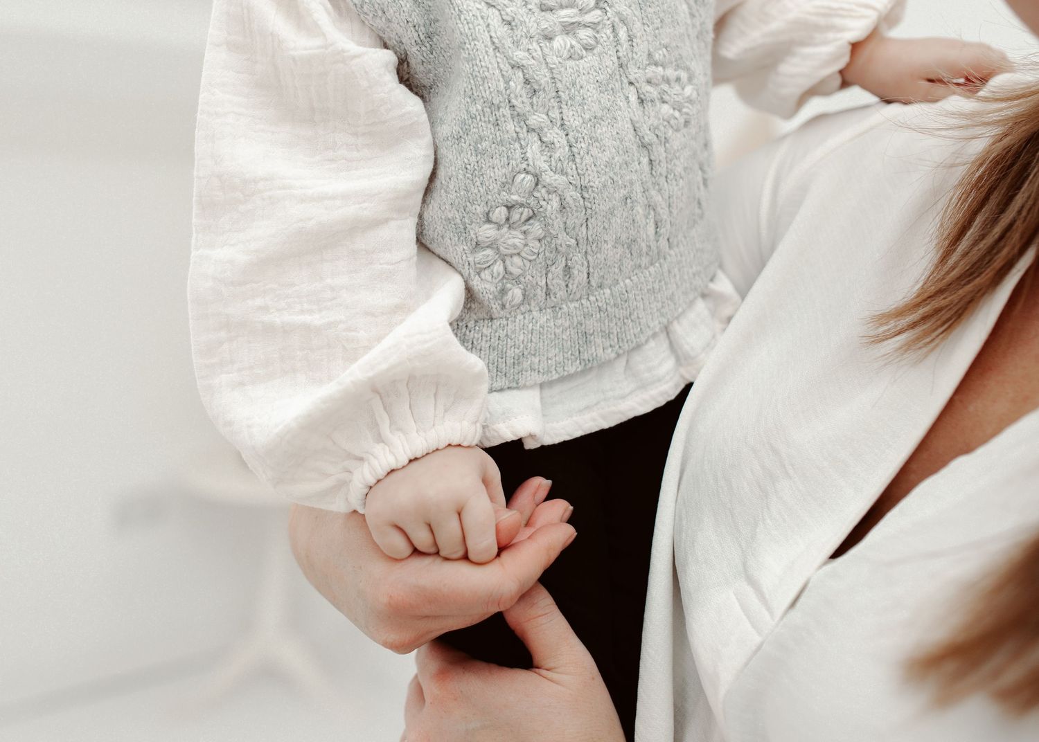 Close-up details of white and gray clothing during a studio portrait session.