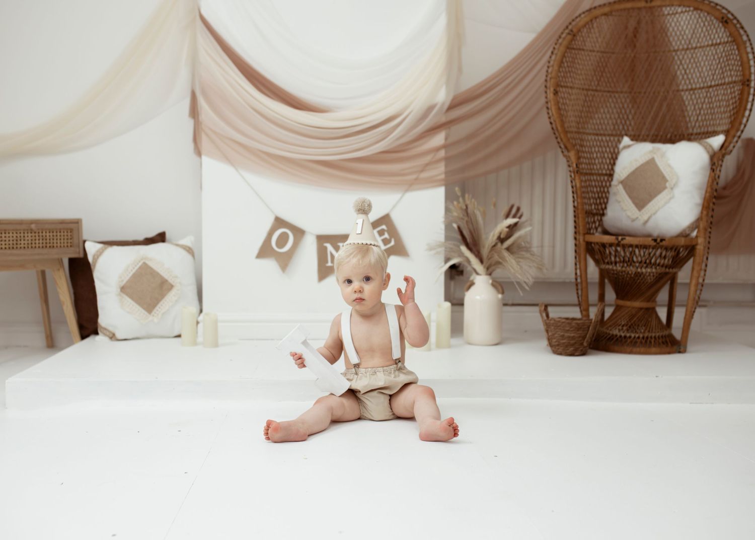 Clean white studio setup with rustic brown banner and decorative elements.