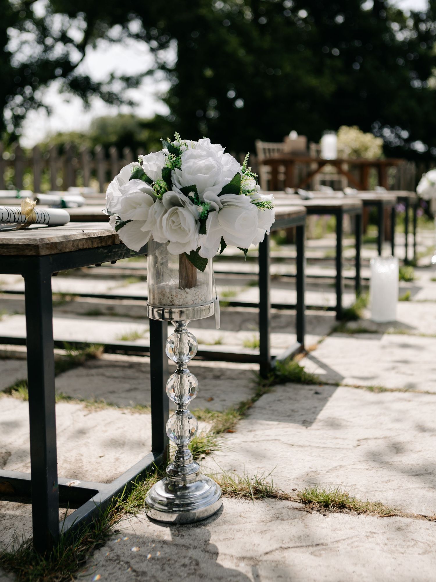 White floral decorations and crystal accents arranged along a stone wall.
