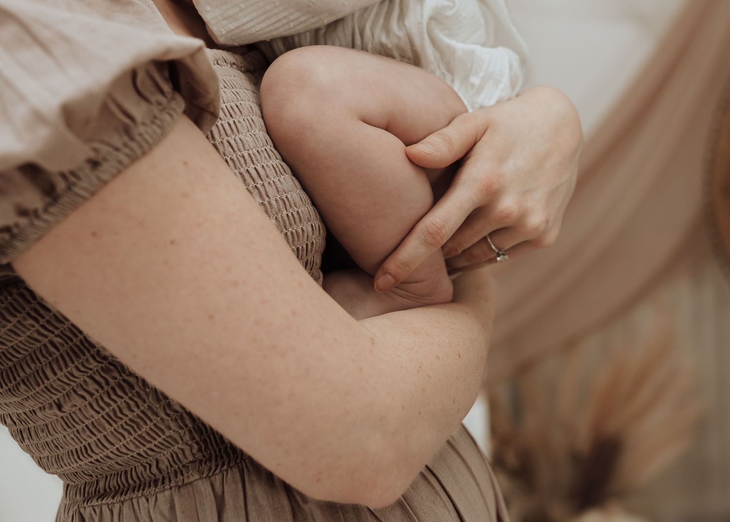 Close-up details of a gentle family photography session in muted tones.