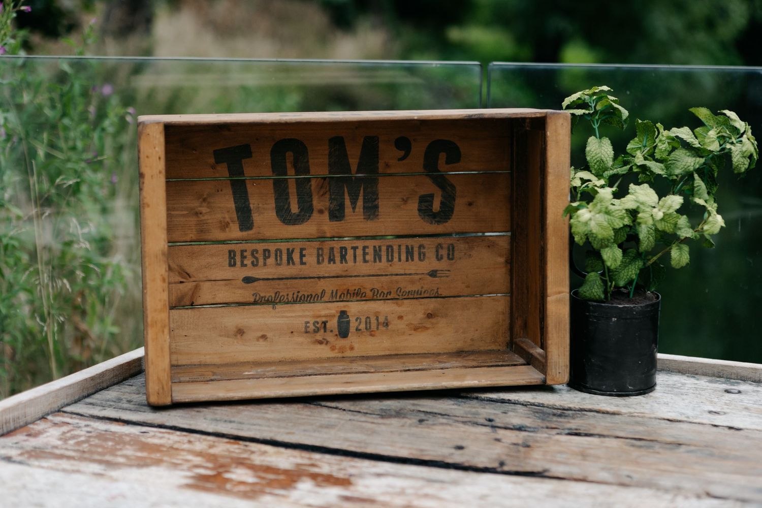 Rustic wooden crates with vintage-style text displayed outdoors.
