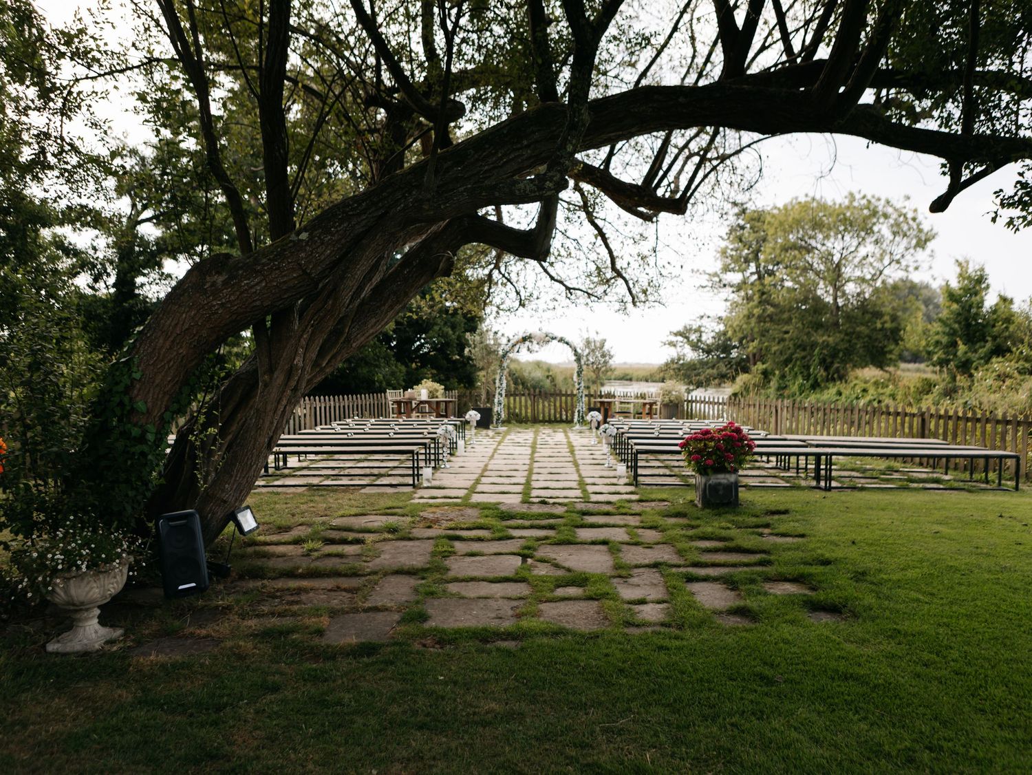 Panoramic view of a scenic outdoor venue with trees and stone steps.