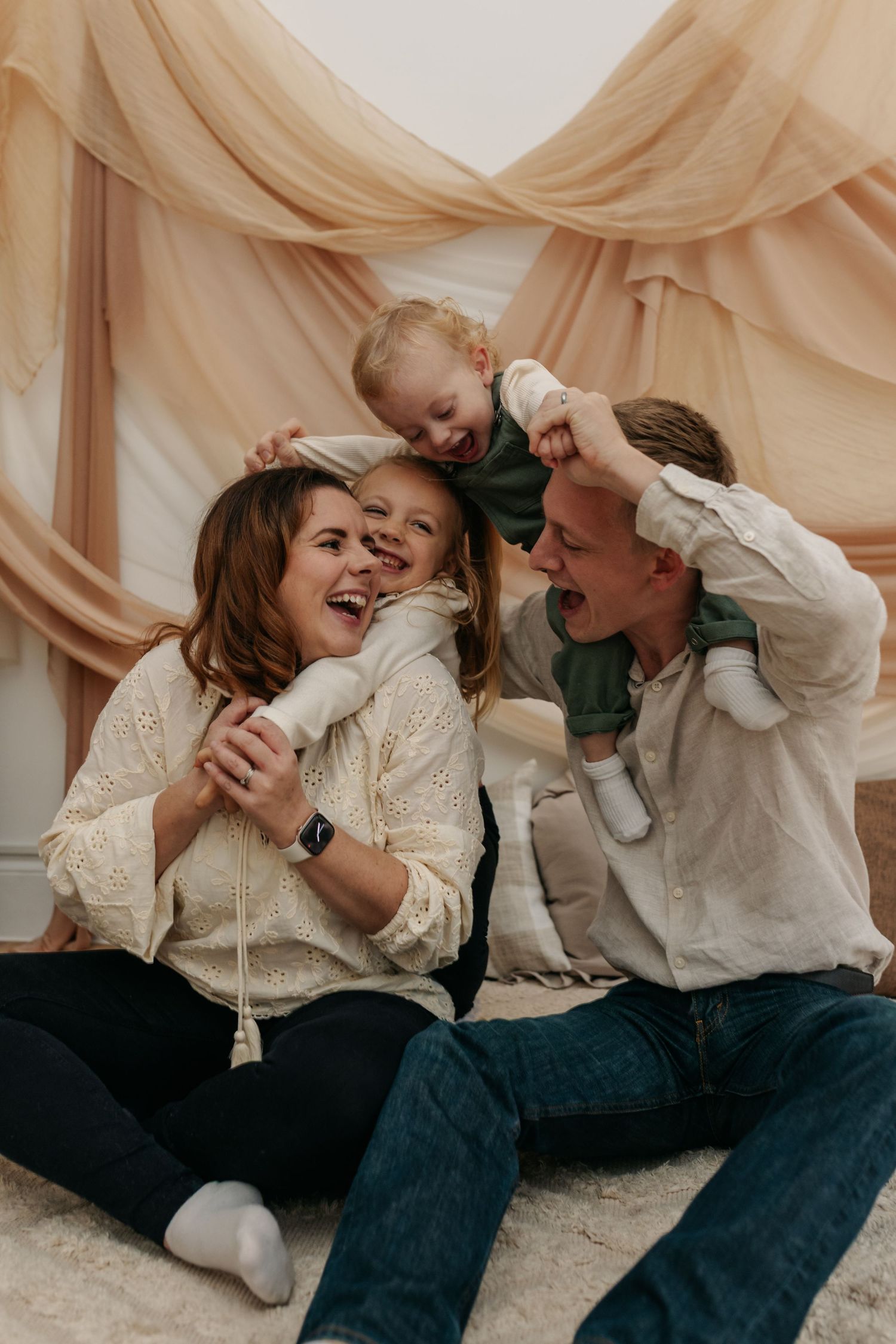 Candid moments of family lying down and laughing together.