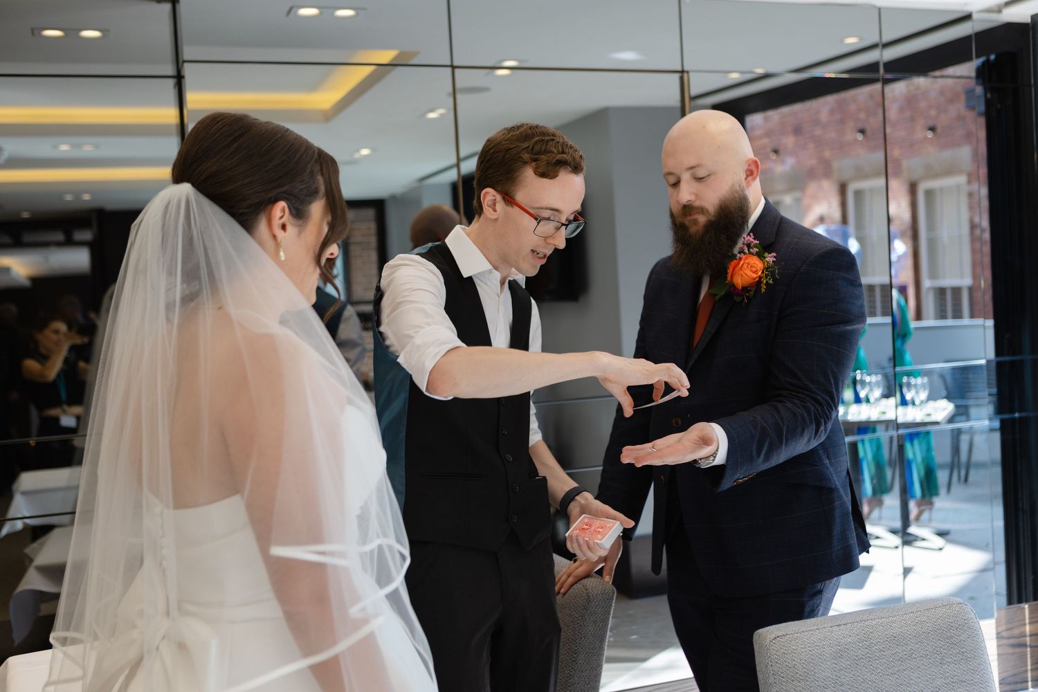 Wedding ceremony moment with guests watching in an indoor venue.