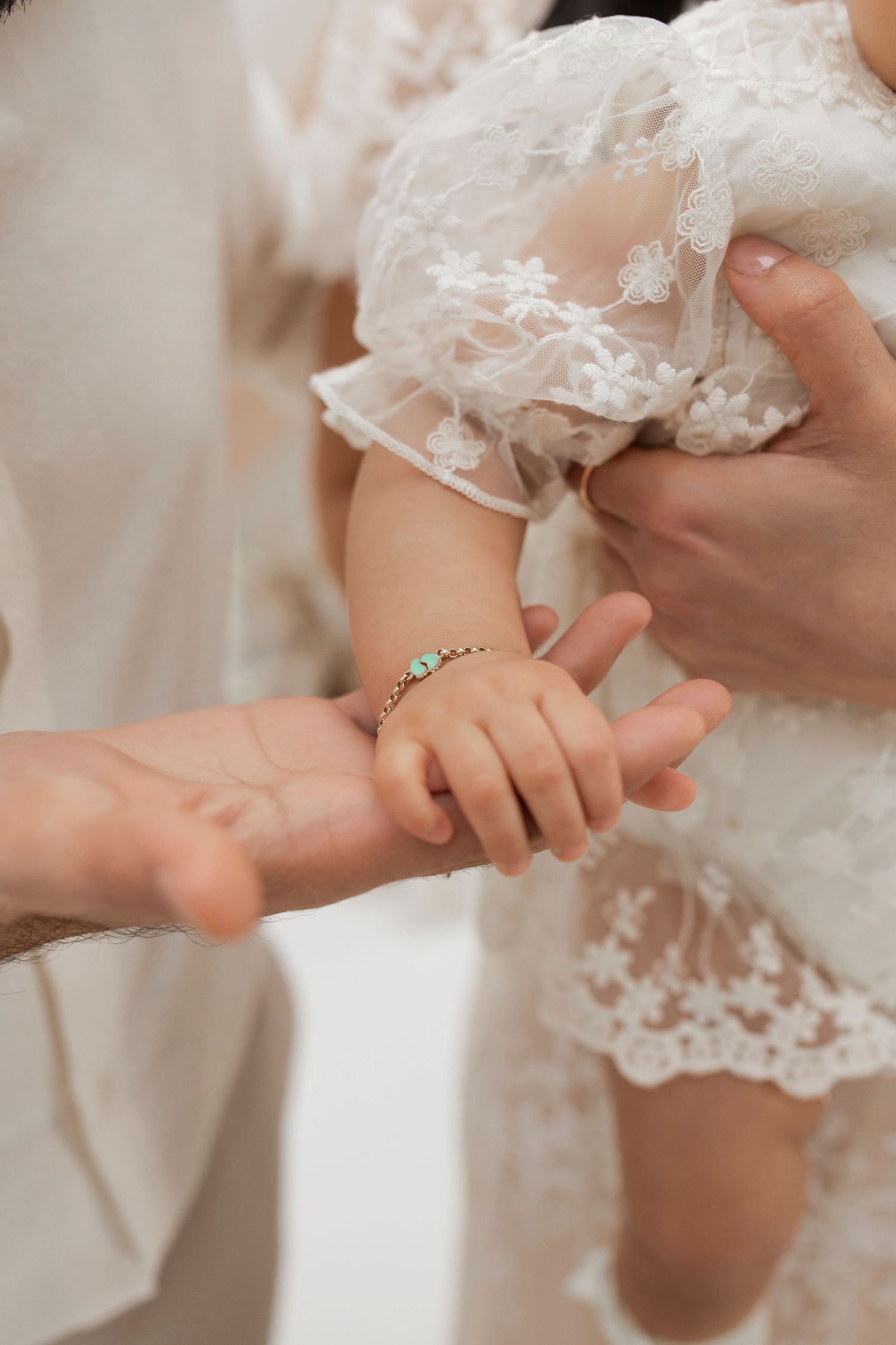 Close-up of delicate lace details on white clothing.