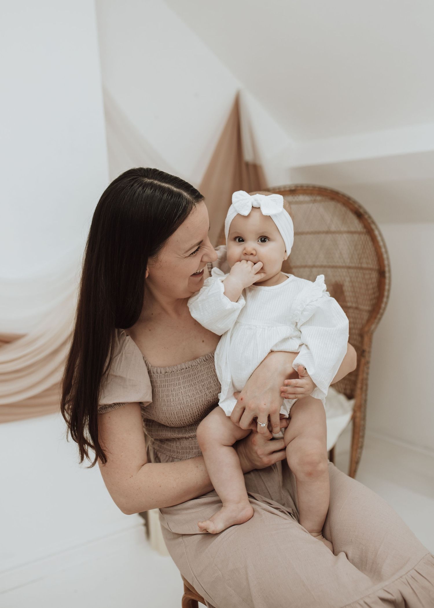 Intimate moments captured during a family photo session with beige and white tones.