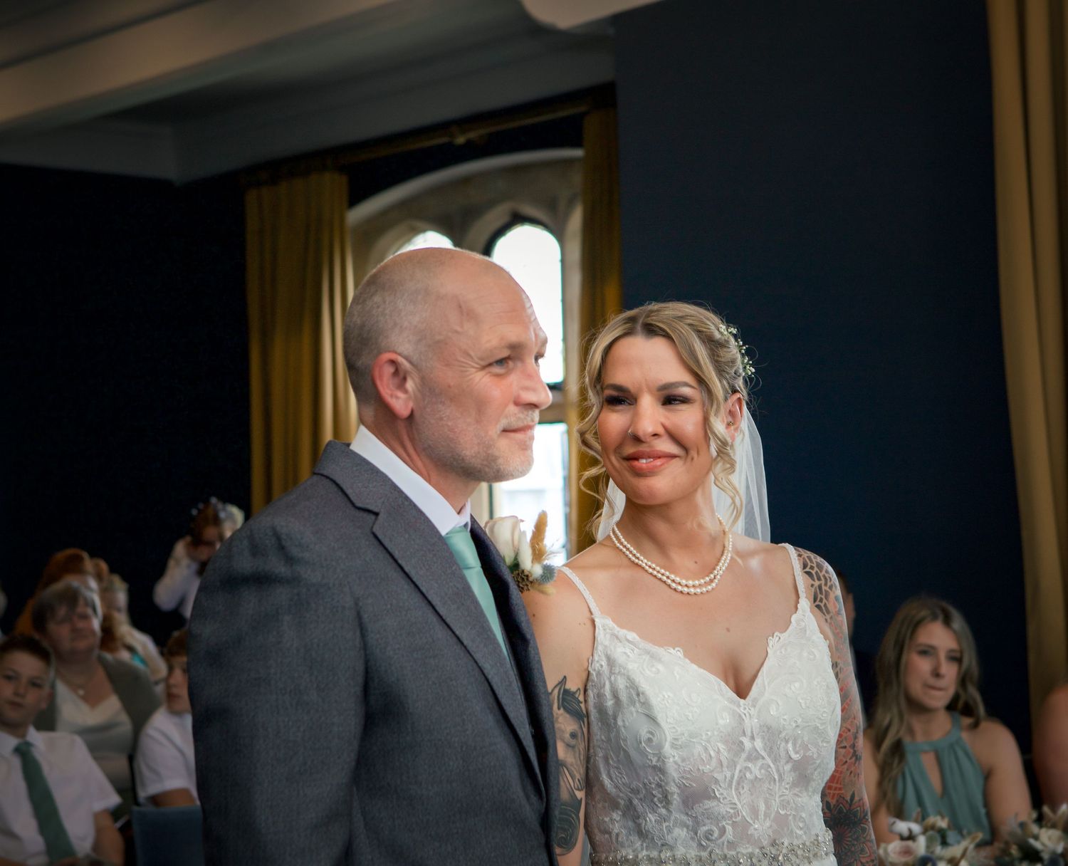 Emotional first look sequence between bride and groom in elegant indoor venue.