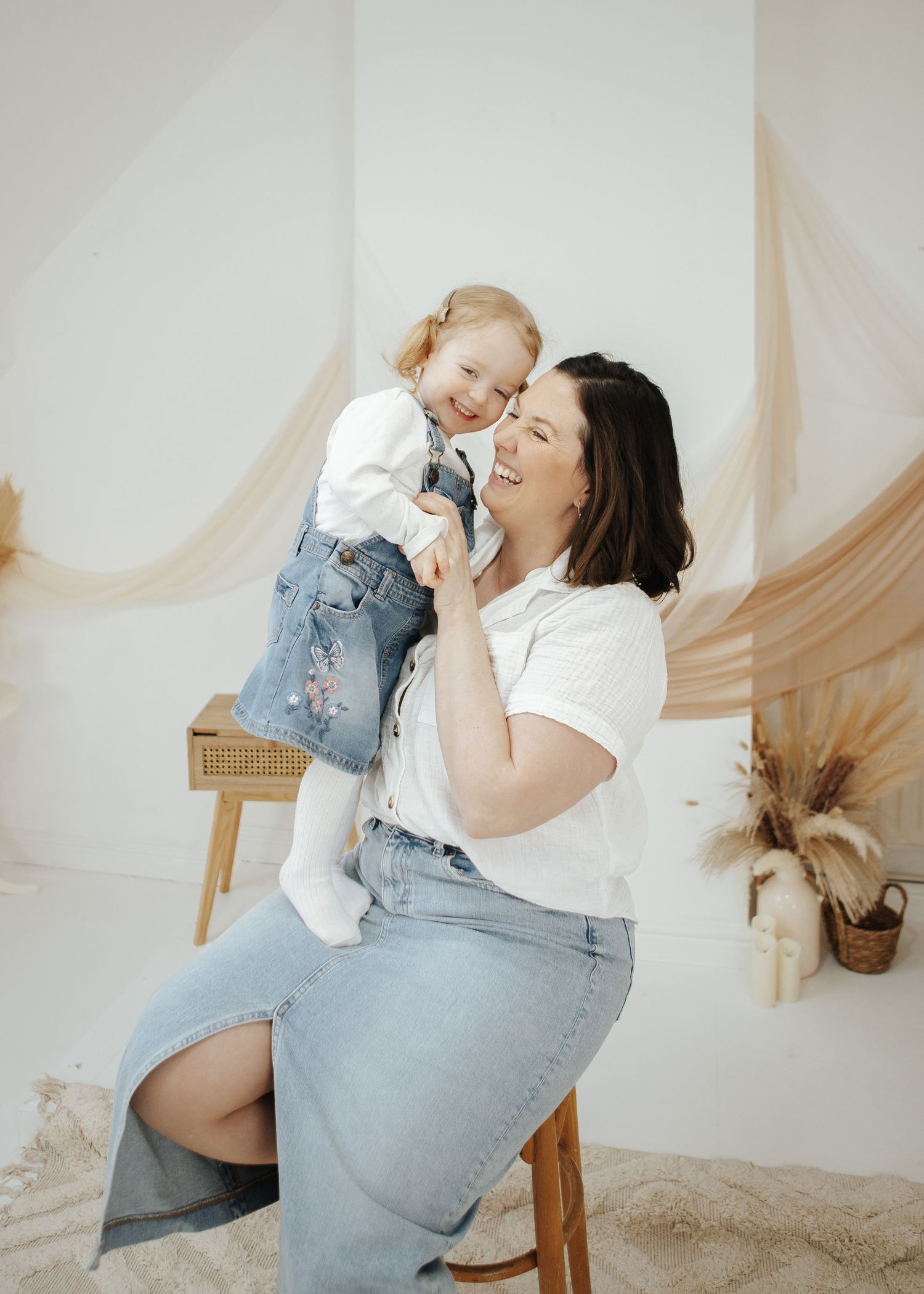 Joyful family moment captured during a professional photo session in coordinated outfits.