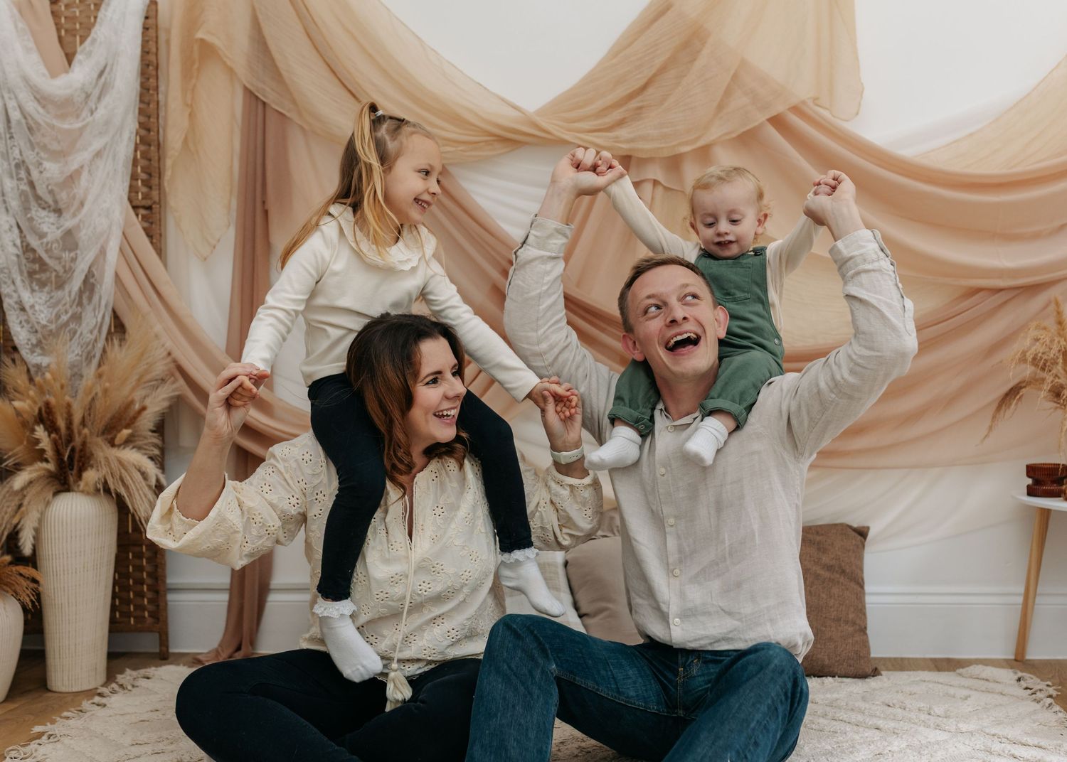 Family sharing genuine laughter during casual photo session.