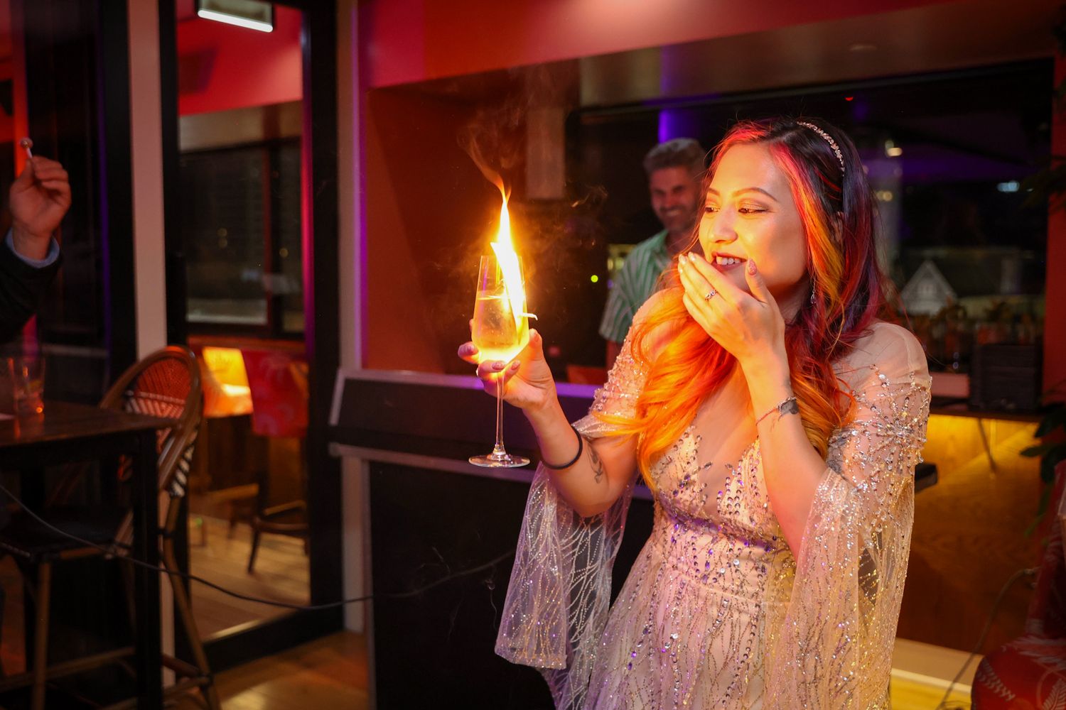 Birthday girl blowing out a candle on her cocktail for her celebration at Mr Brightside Rooftop Bar in Christchurch
