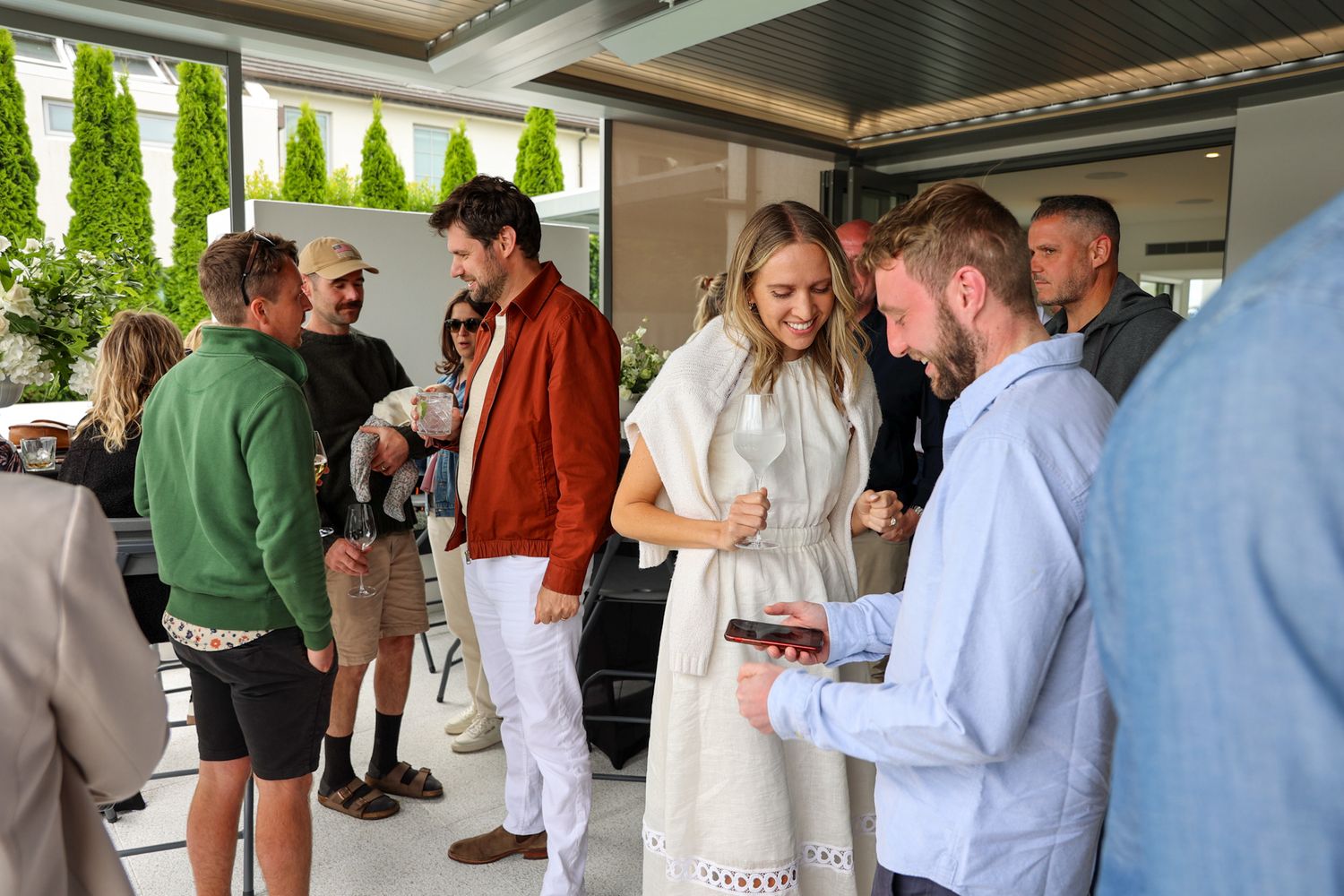 A group of guests mingling at a party in a group