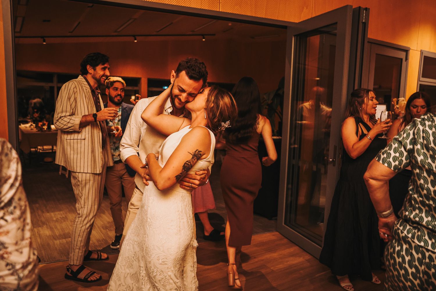 Newly married couple sharing a kiss and dancing together during their first dance