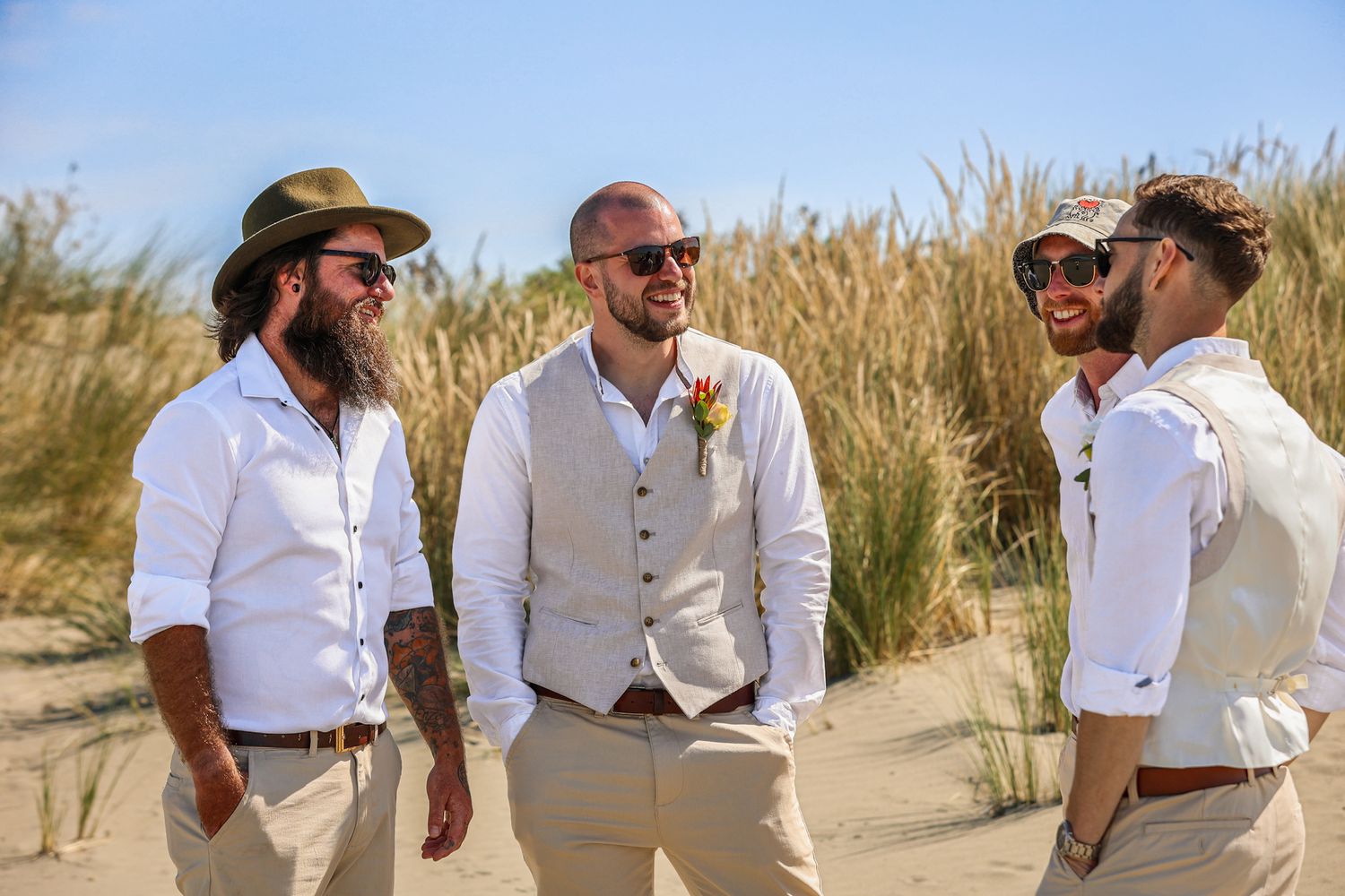 Groom and groomsman chatting in a group after the ceremony