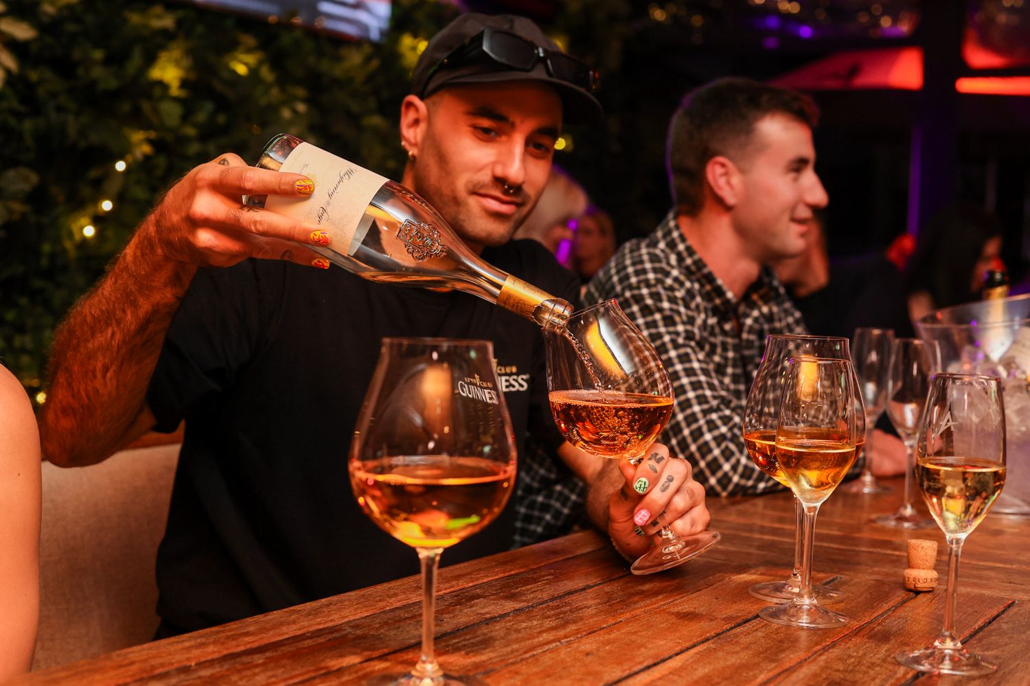 Boys pouring a glass of whispering Angel french rosé
