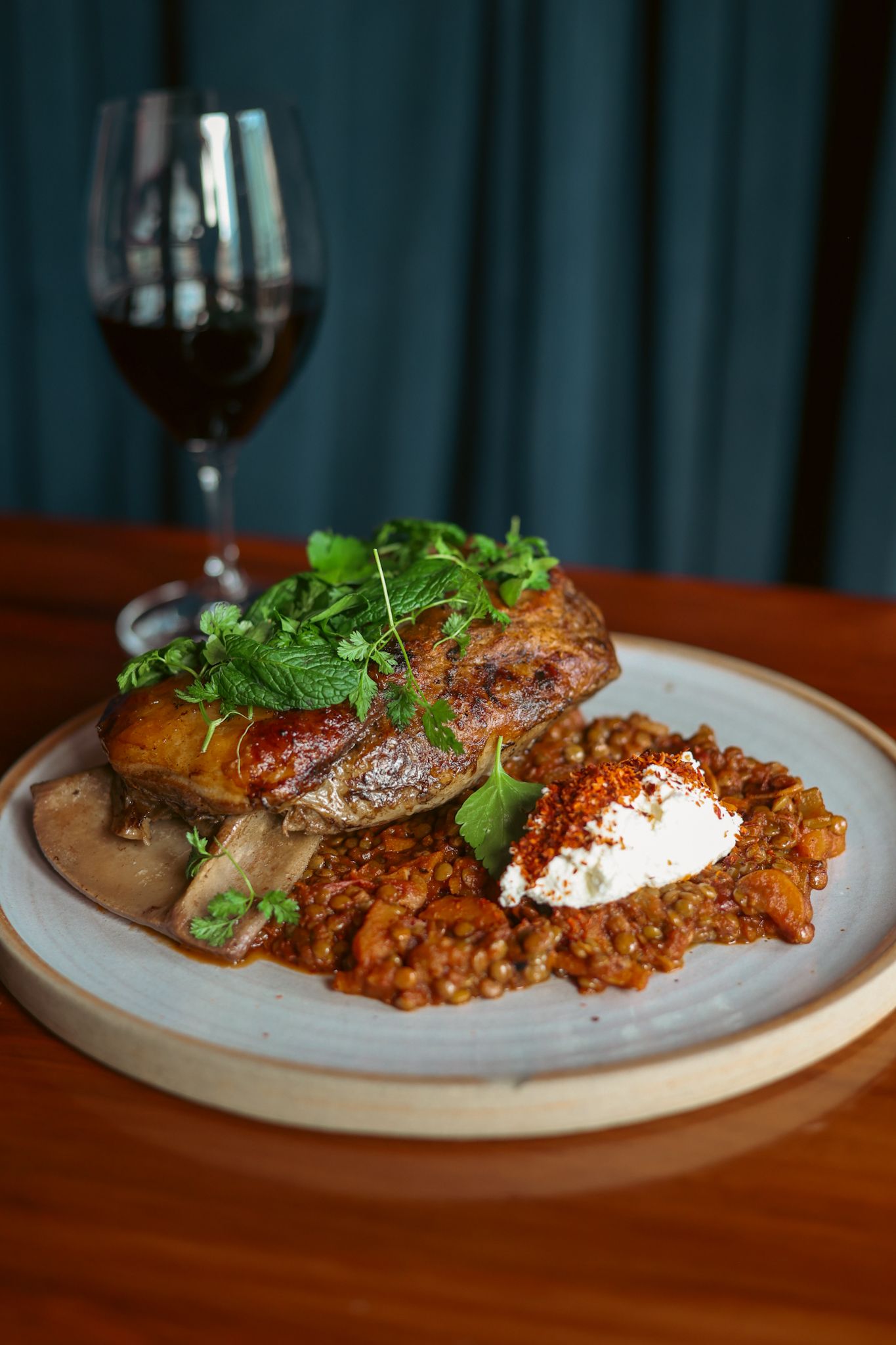 Slow roasted lamb with a glass of red wine at Gin Gin Christchurch