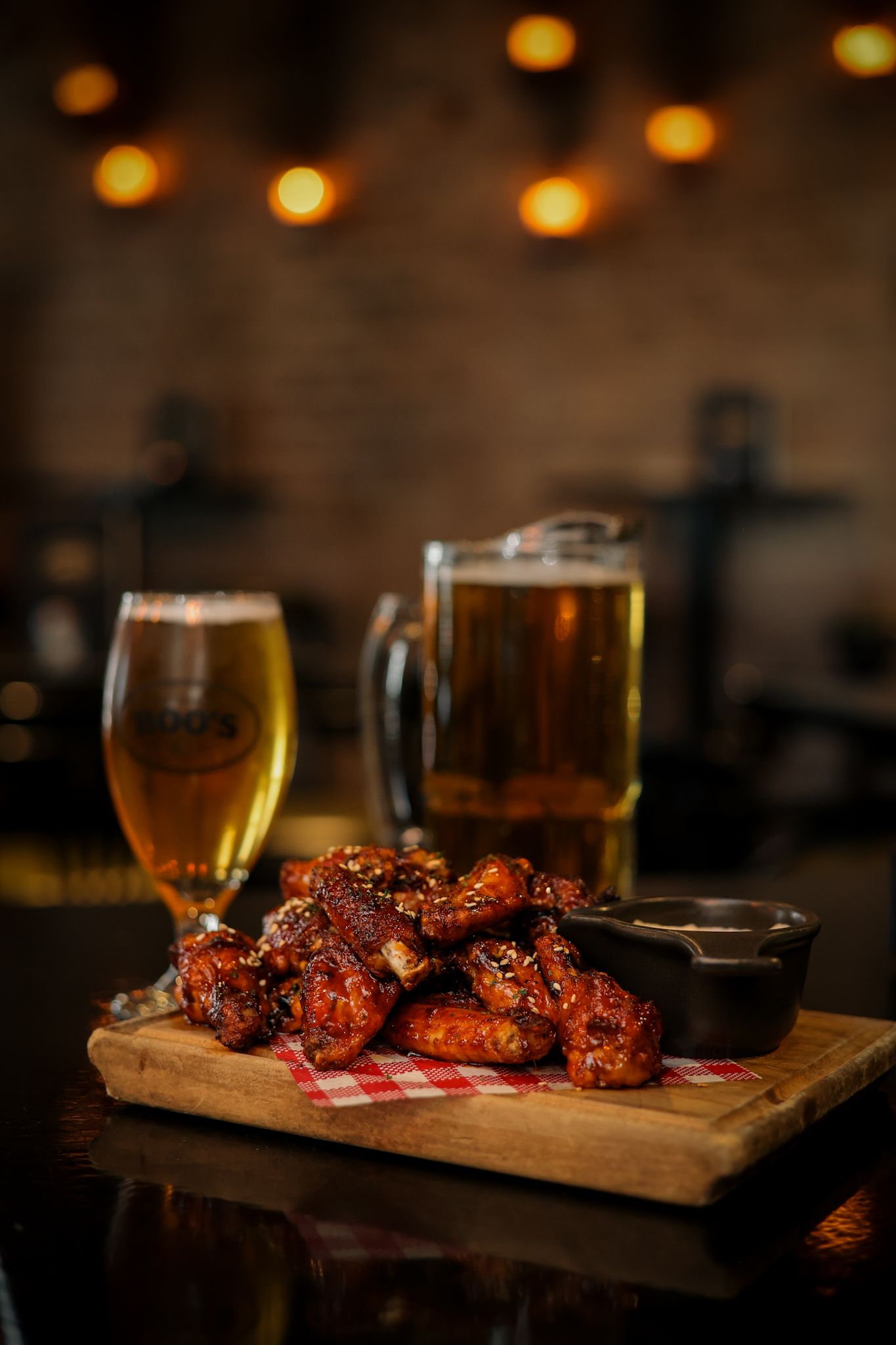 Jug of beer and a plate of fried chicken wings at Boo’s Bar, Christchurch