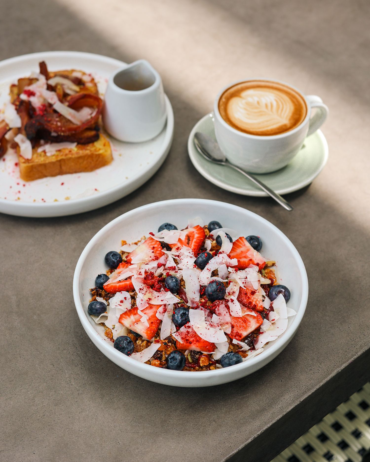 Breakfast muesli blueberry and strawberry bowl with a latte coffee at Brigittes Merivale