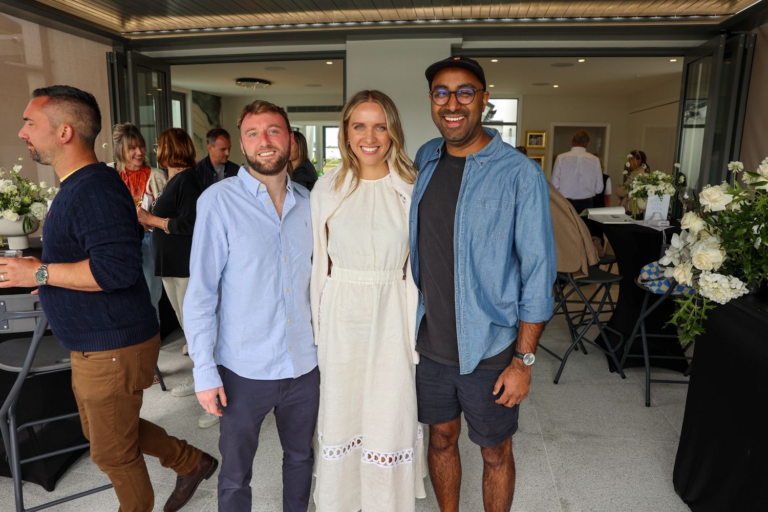 Three people at a party having their photo taken.