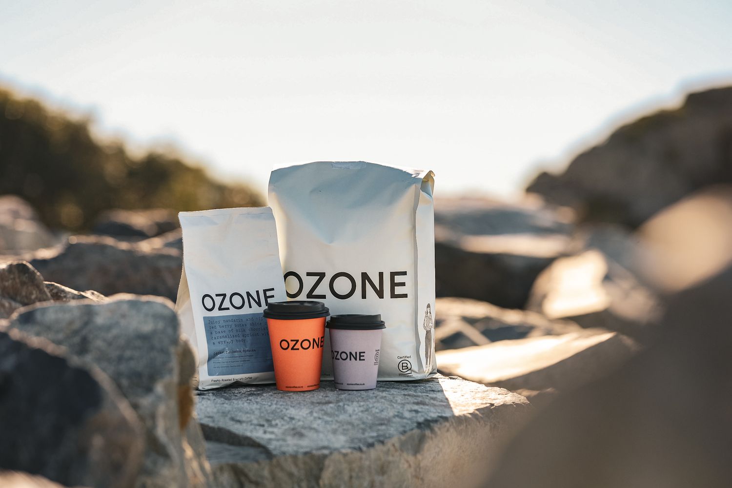 OZONE Coffee Roaster bean bad, decaf bag and coffee cups on Sumner Beach, Christchurch