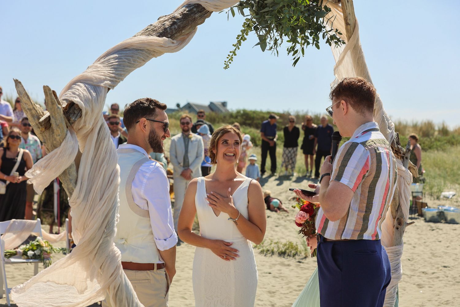 Bride looking at the officiant smiling during the ceremony