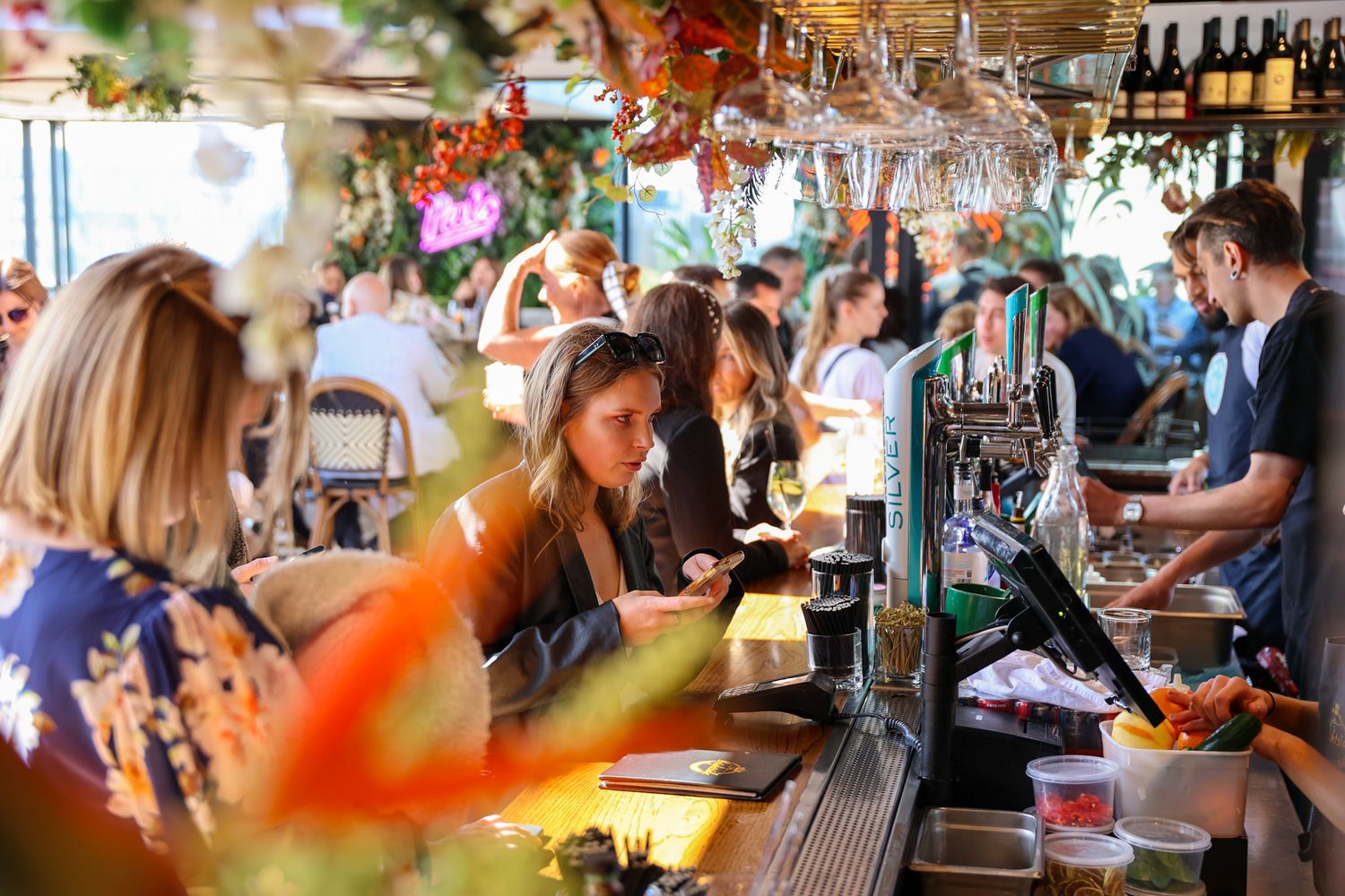Customers ordering a drink at Mr. Brightside Rooftop Bar on a sunny afternoon