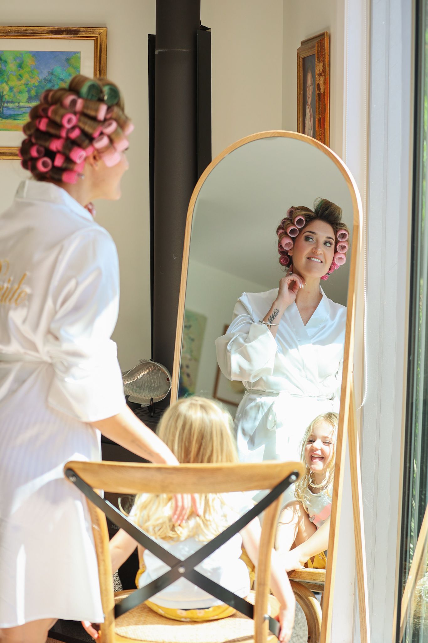 Bride examining her makeup in the mirror with her daughter