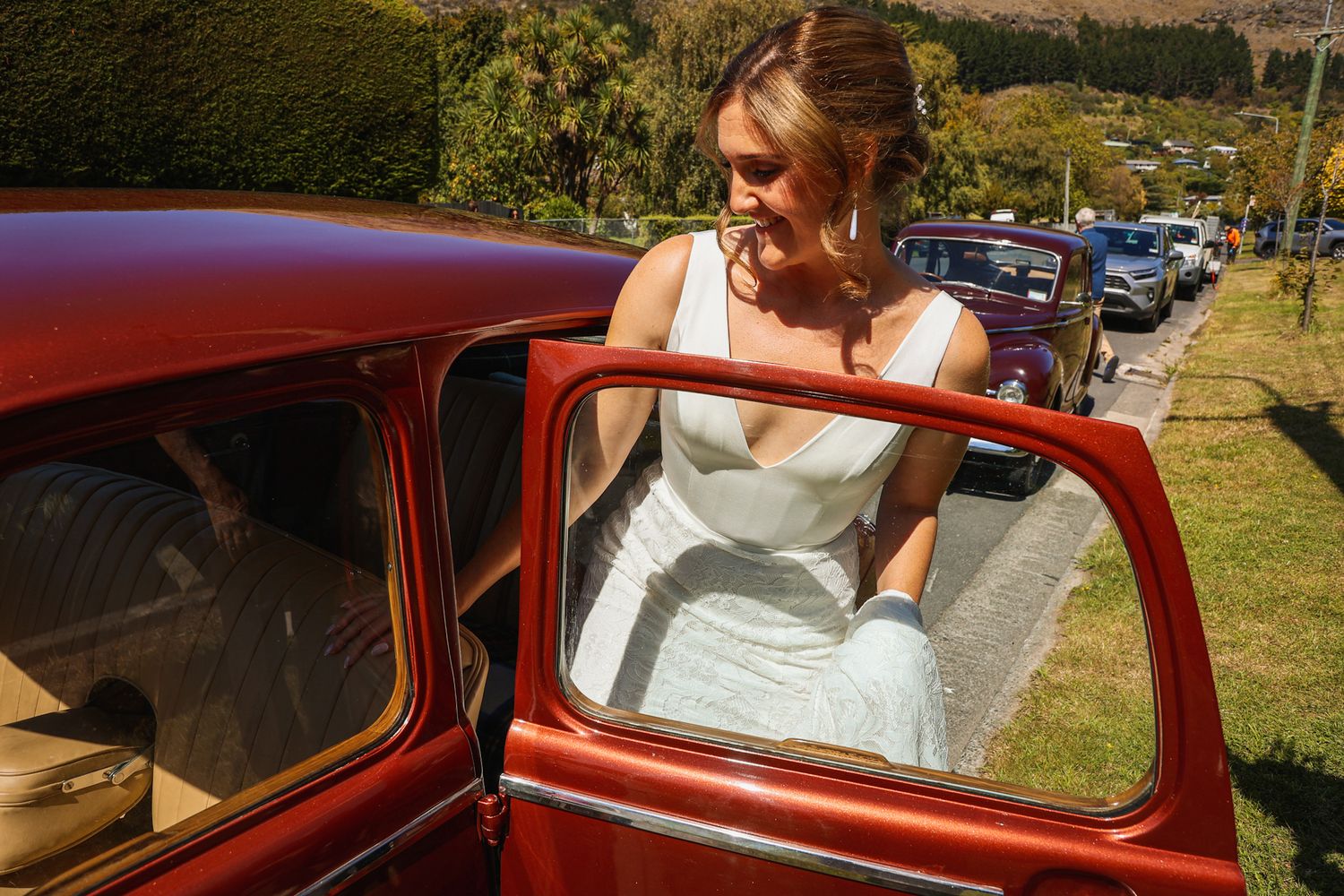 Bride stepping into her classic car before making her way to her wedding ceremony