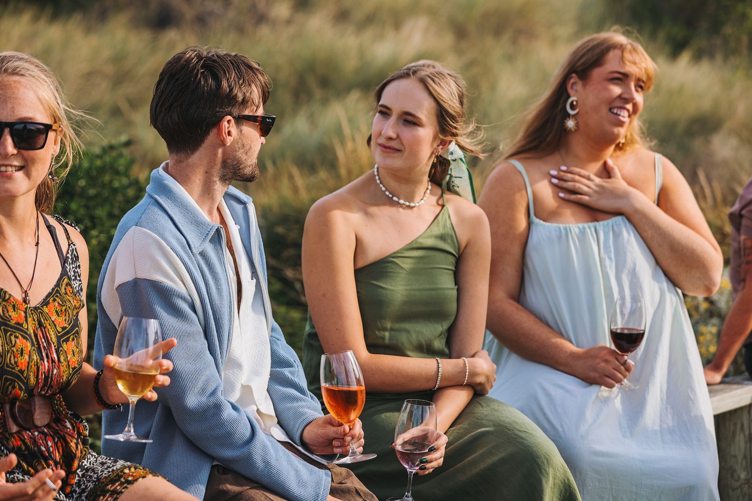 Wedding guests mingling and conversations during golden hour