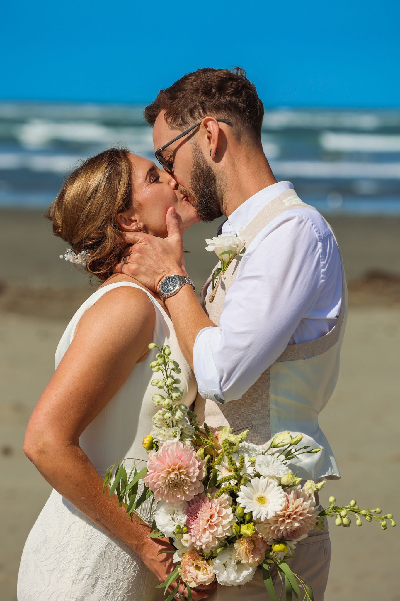 A couple sharing their first kiss as husband and wife on New Brighton Beach, Christchurch.