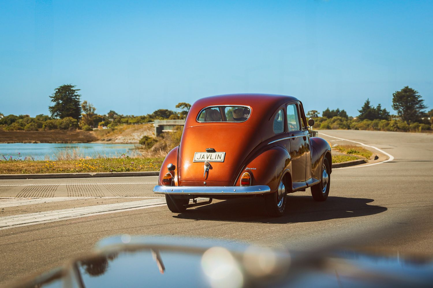 Classic car on route to the wedding, bride and mother inside the vehicle