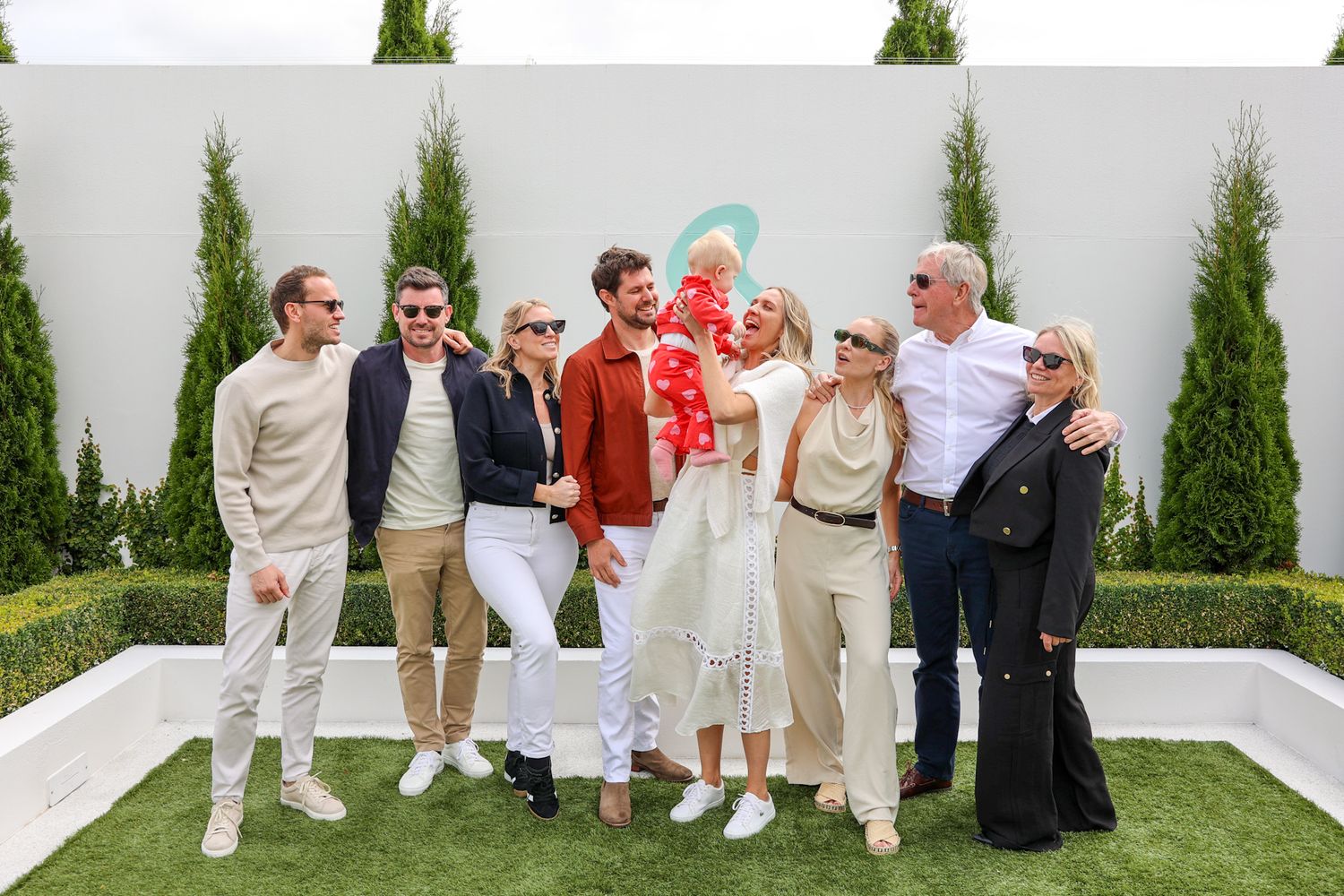 A family having their group photo taken at a party.