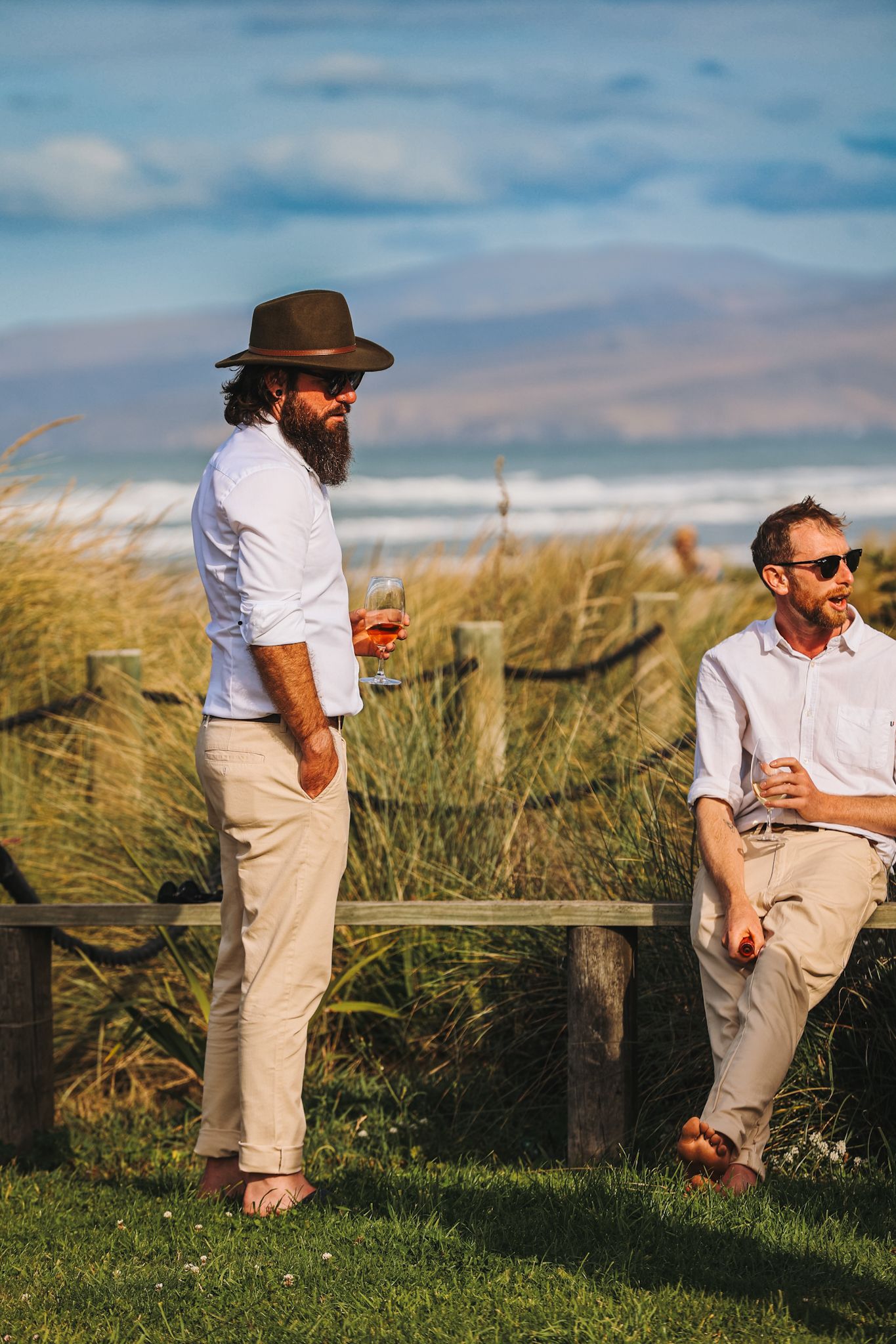 Wedding guests against the backdrop of the beach at golden hour
