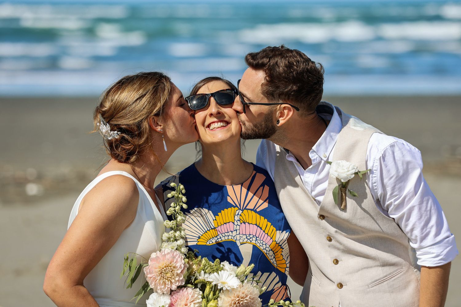 Bride and Groom kiss their officiant for a humorous photo opportunity