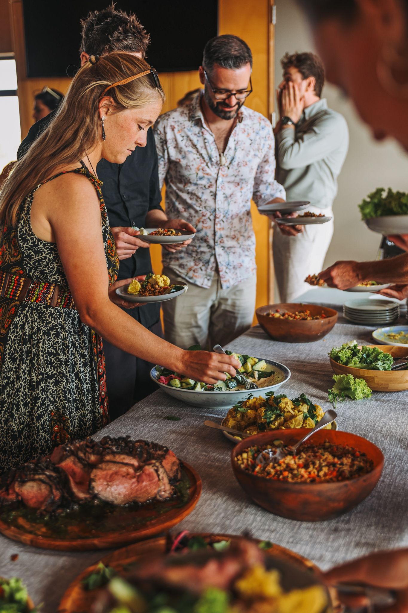 Guests at a wedding plating up from a buffet table