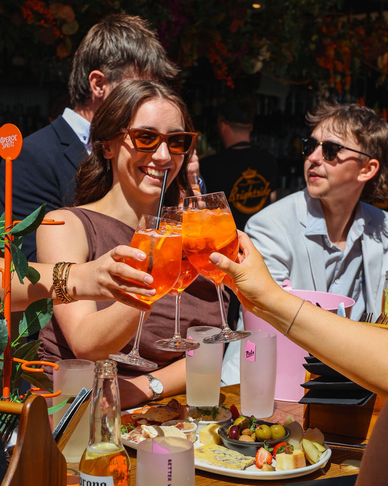 Cheersing a round of Aperol Spritz in the sunshine