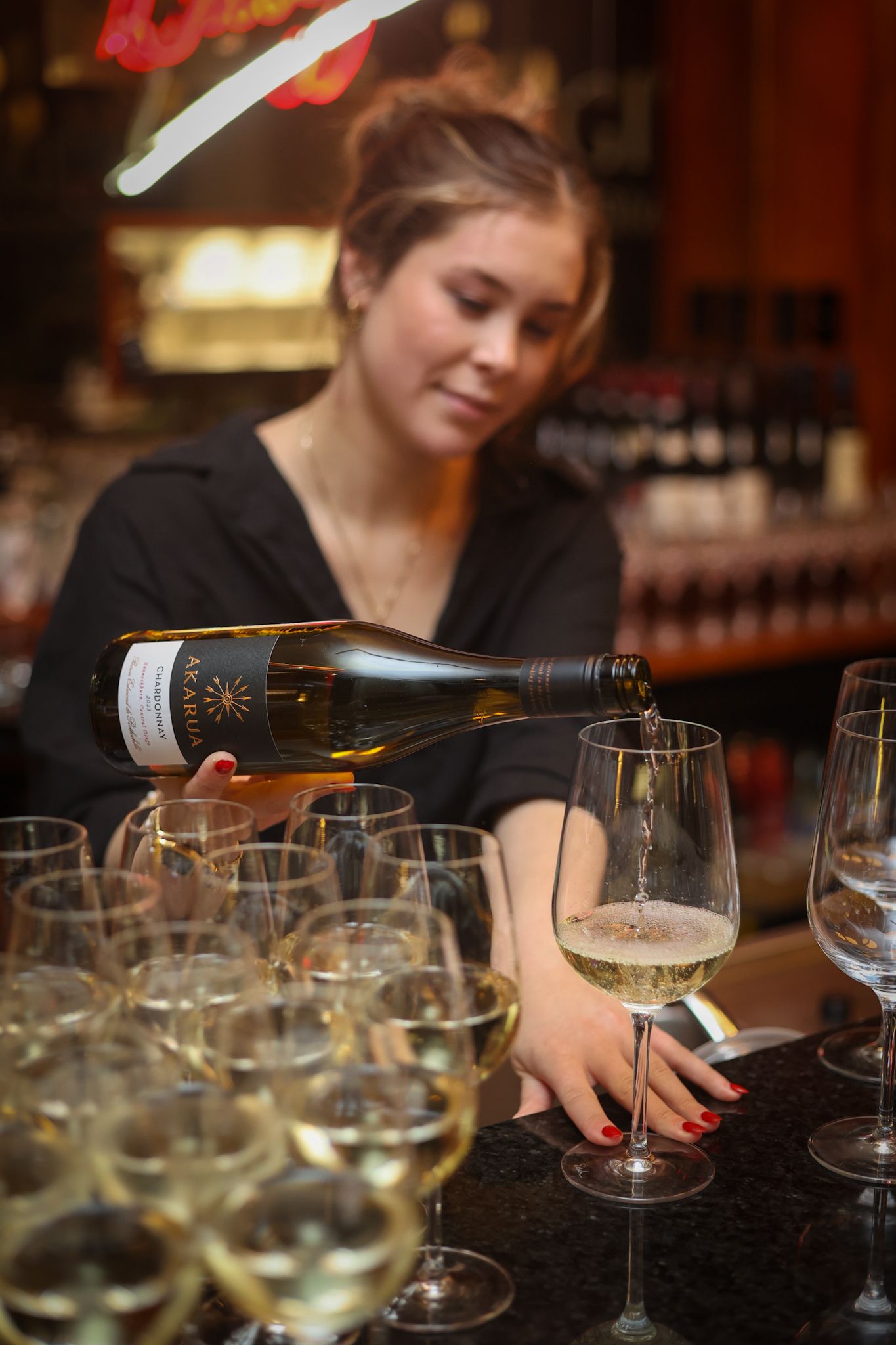 Waitress pouring a glass of wine