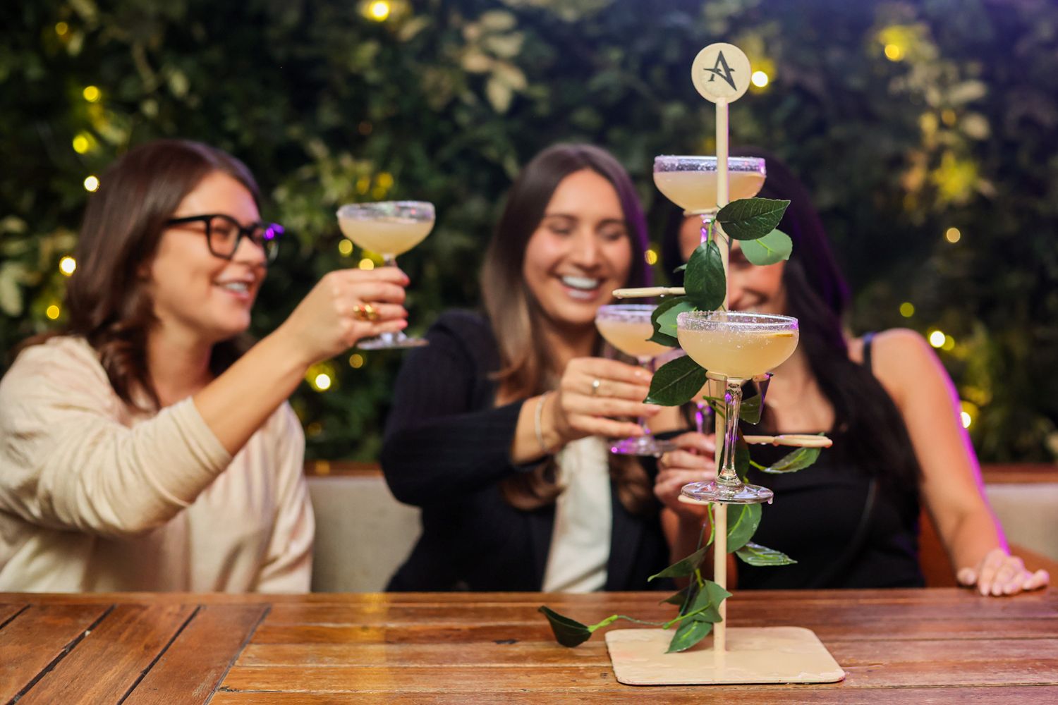 Girls cheersing a round of margarita cocktails