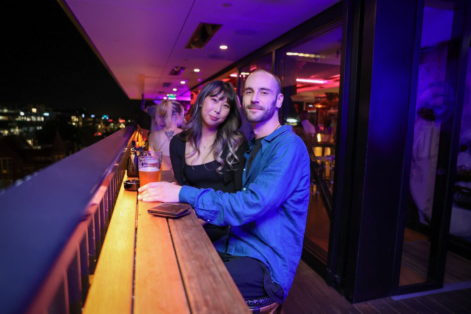 Party guests sitting on the balcony at Mr. Brightside Rooftop Bar in Christchurch during a function