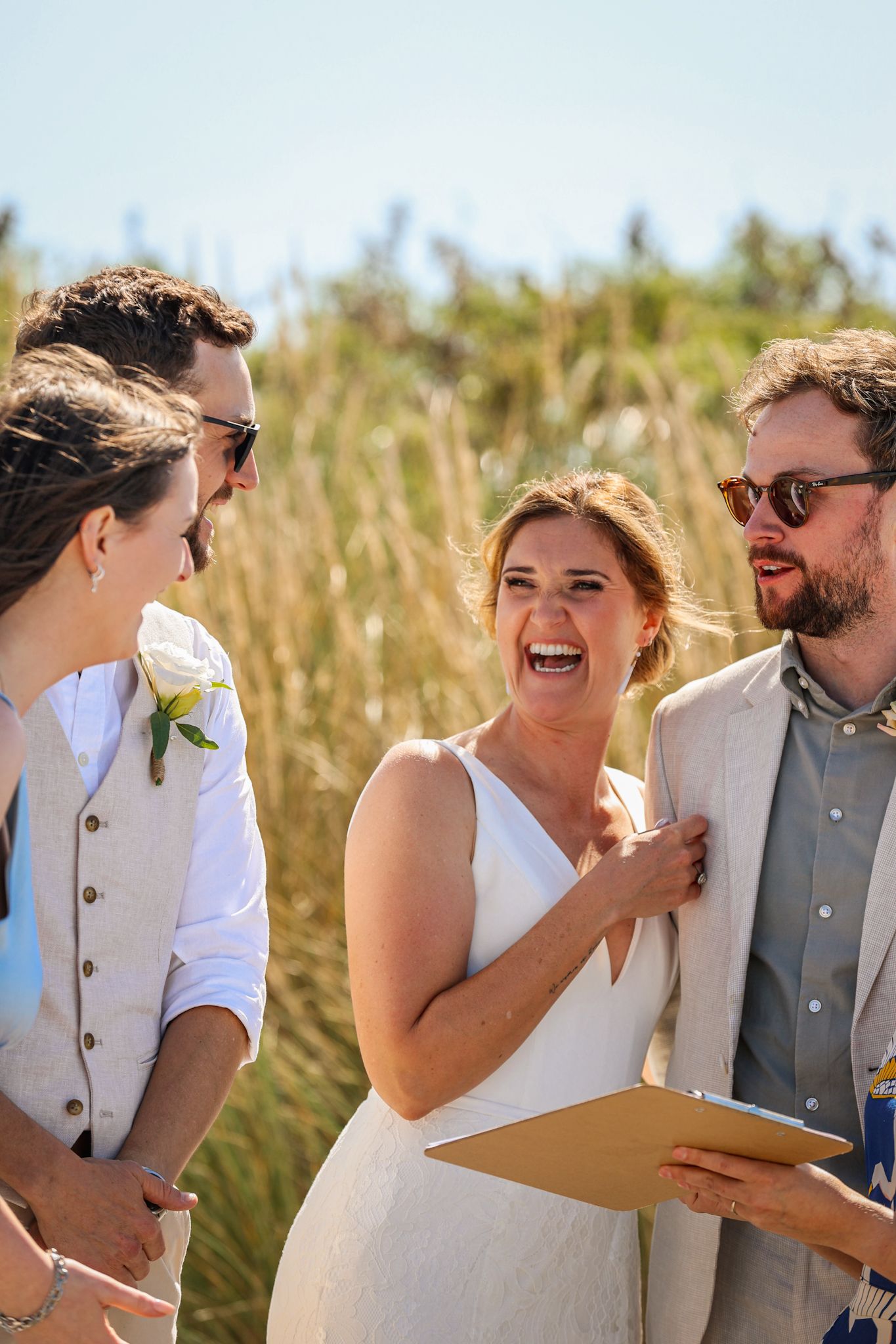 Bride laughing whilst signing the marriage documents
