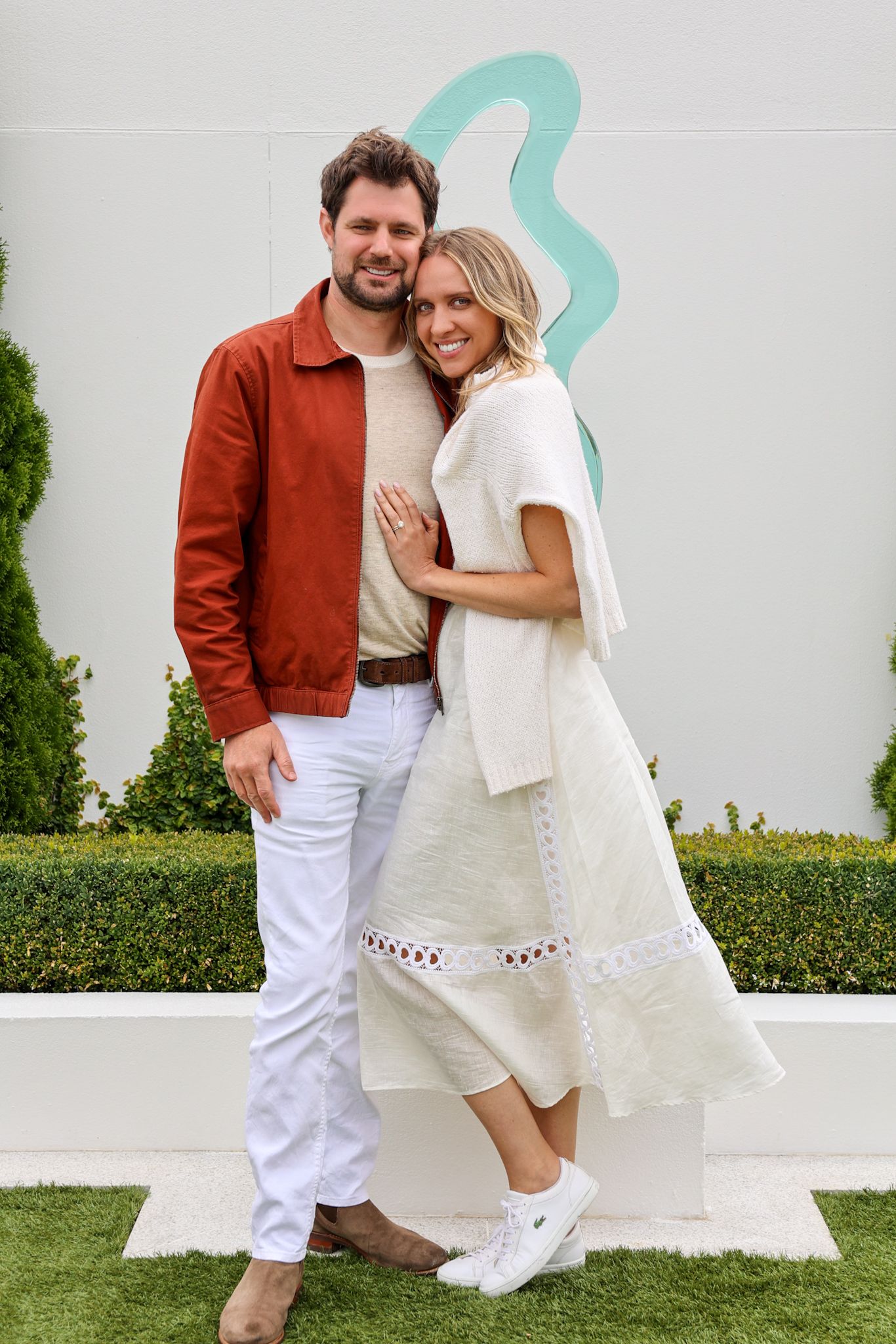 A couple at their wedding after party standing for a posed photograph.