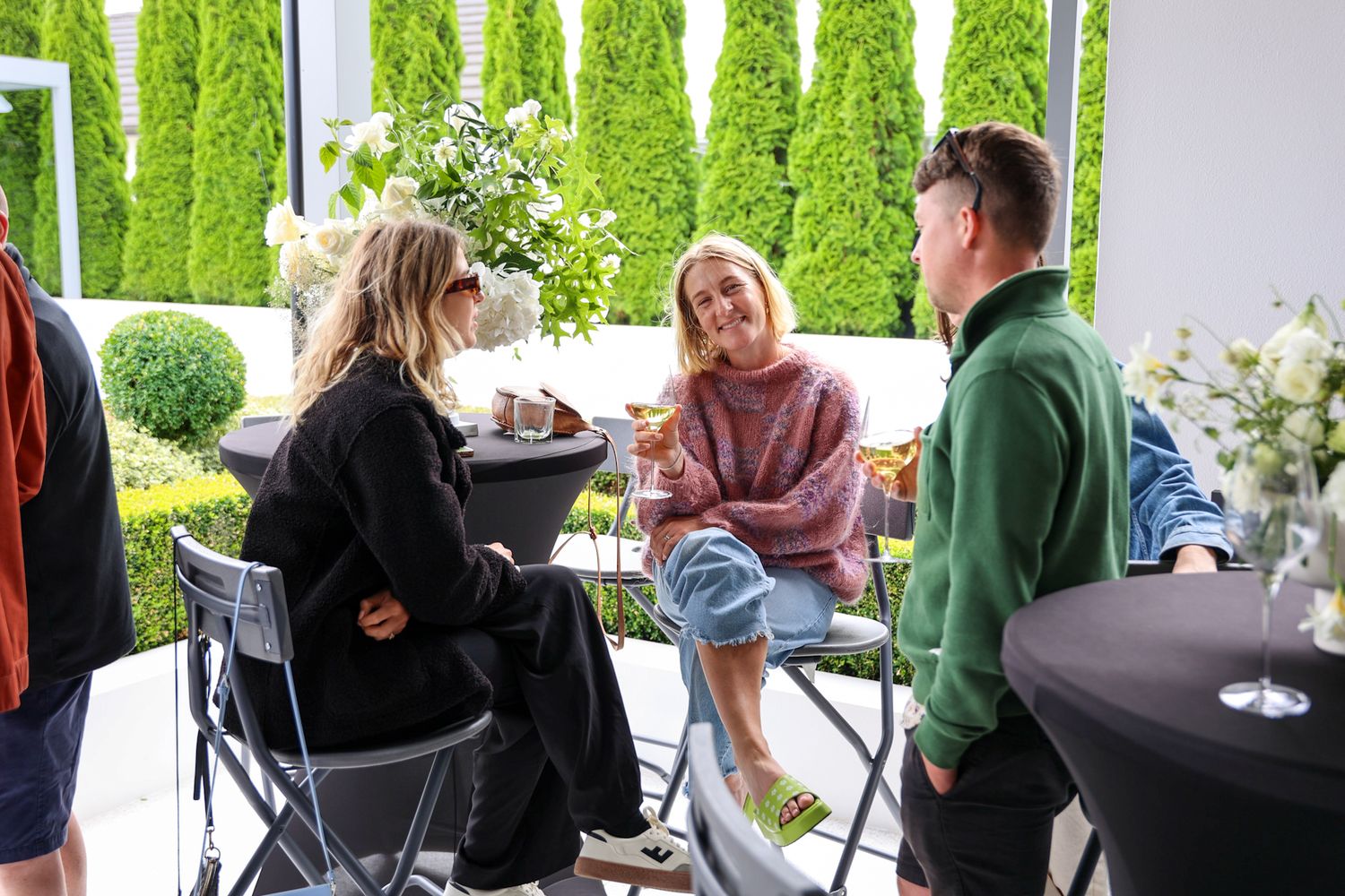 Three people at a party having their photo taken.