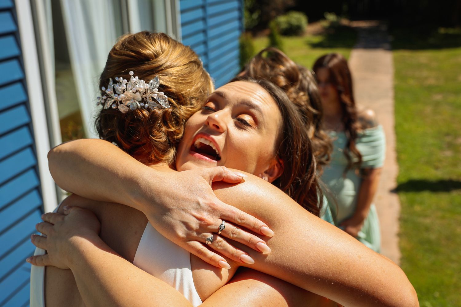 Bride hugging her soon-to-be sister-in-law during an emotional first look