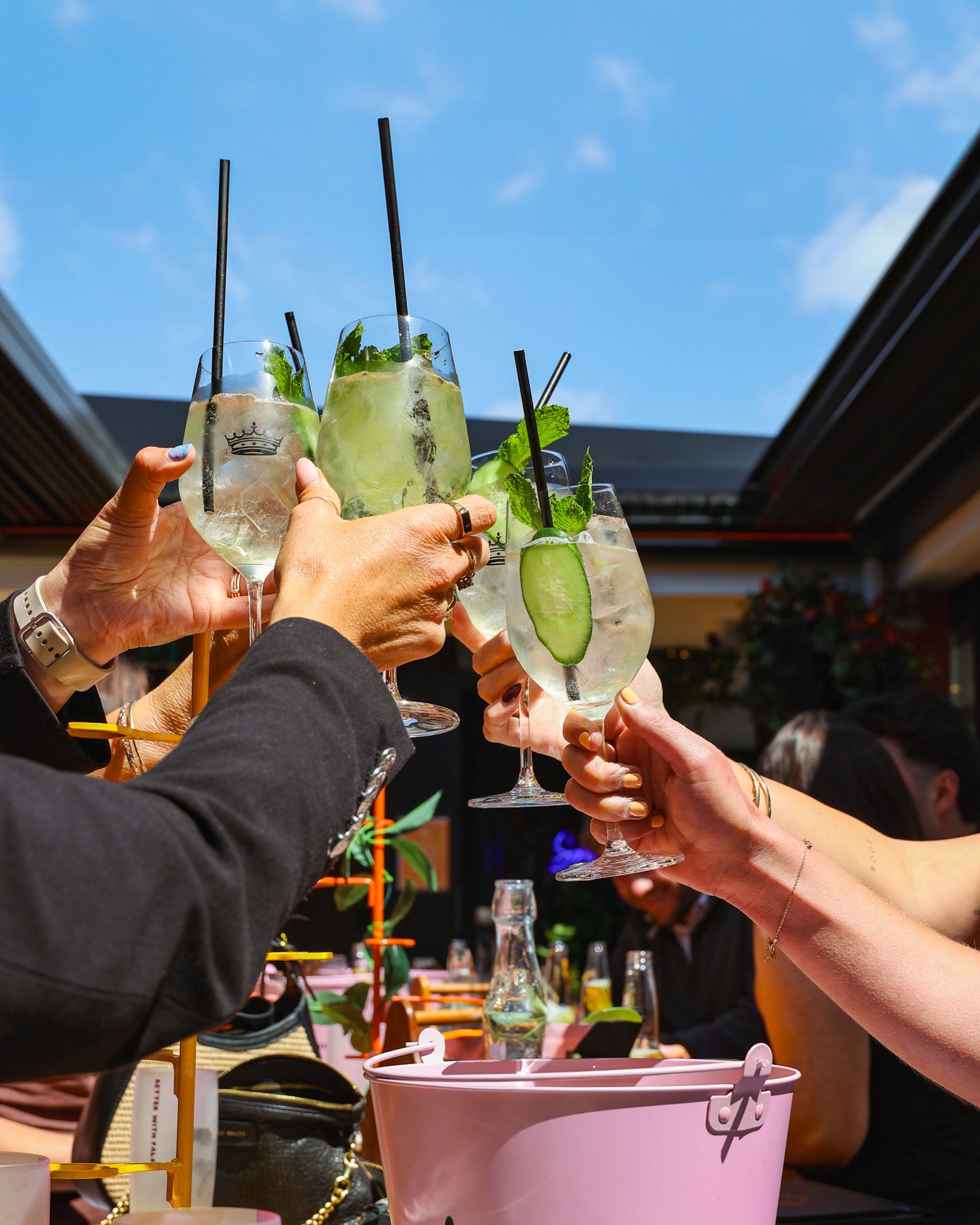 Cheersing a round of cocktails in the sunshine