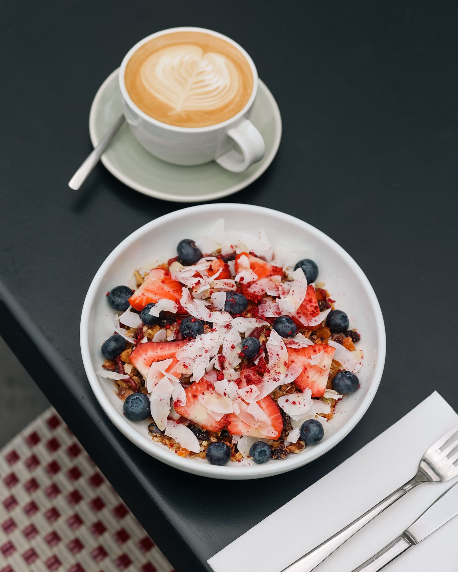 Breakfast muesli blueberry and strawberry bowl with a latte coffee at Brigittes Merivale
