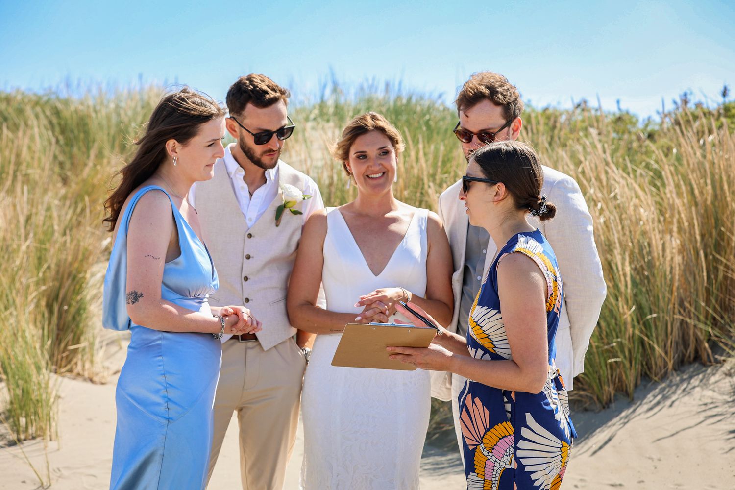 Bride, groom, officiant and witnesses gathered together before signing the marriage documents